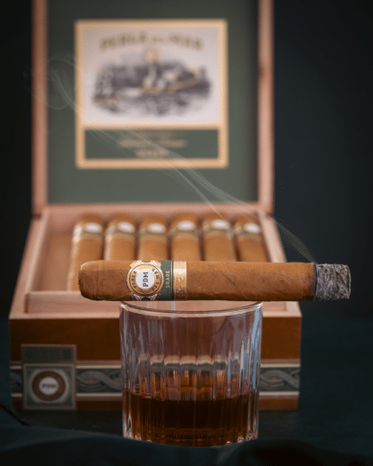 Perla del Mar Shade on a Whiskey Glass in front of an open box