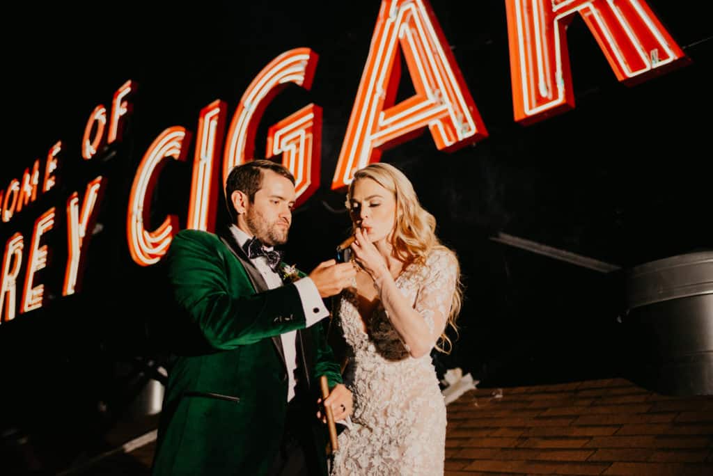 Man lighting a woman's cigar