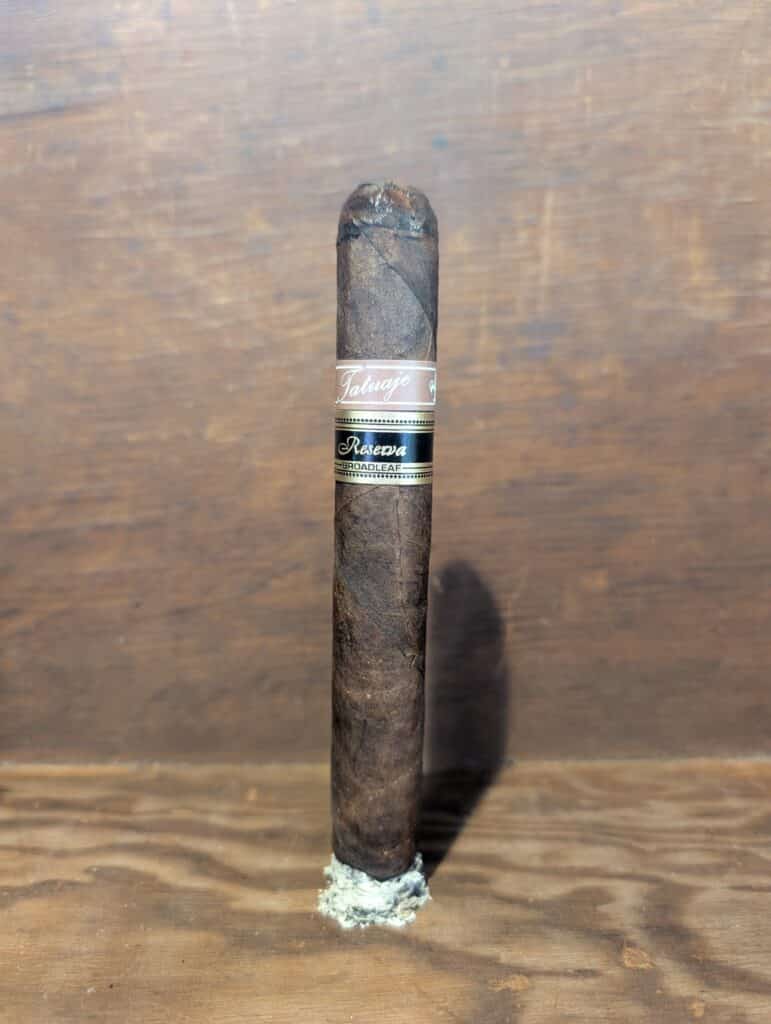 Tatuaje Cojonú standing on its ash
